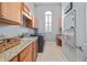 Well-appointed laundry room features granite counters, sink, washer, dryer, and ample cabinet space at 4512 Cheval Blvd, Lutz, FL 33558