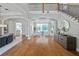 Open-concept living area boasts gleaming hardwood floors, archways, and a view to the backyard at 4512 Cheval Blvd, Lutz, FL 33558