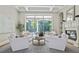 Bright living room features coffered ceilings, a fireplace, and large windows overlooking the backyard pool at 4512 Cheval Blvd, Lutz, FL 33558