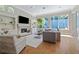 Comfortable living room with fireplace, built-in shelving, and large windows at 4512 Cheval Blvd, Lutz, FL 33558