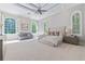 Relax in this large main bedroom retreat featuring large windows and a seating area at 4512 Cheval Blvd, Lutz, FL 33558