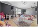 Bright playroom featuring a movie projector, sleek shelving, and an array of toys for creative playtime at 4512 Cheval Blvd, Lutz, FL 33558