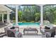 Beautiful outdoor space with a large pool, a spa, and screened-in patio with seating area at 4512 Cheval Blvd, Lutz, FL 33558