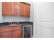 Convenient wet bar area perfect for entertaining, featuring granite countertops and beverage cooler at 4512 Cheval Blvd, Lutz, FL 33558