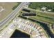 This aerial view shows community and surroundings, highlighting the lush greenery, water features, and convenient location at 4888 Sevilla Shores Dr, Wimauma, FL 33598