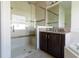 Bathroom with a glass shower, granite countertops, and a dark wood vanity cabinet at 4888 Sevilla Shores Dr, Wimauma, FL 33598