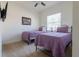 Bedroom with twin beds, neutral carpet, and a framed Marvel comic book poster at 4888 Sevilla Shores Dr, Wimauma, FL 33598