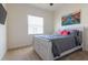 Bedroom with a light wood bed frame, neutral carpet, and a Venetian canal painting at 4888 Sevilla Shores Dr, Wimauma, FL 33598
