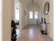 Light and bright foyer with decorative ceilings, tile floors, and a view of the entryway at 4888 Sevilla Shores Dr, Wimauma, FL 33598