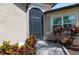Close up of the screened-in front porch and paver walkway leading to the front door at 4888 Sevilla Shores Dr, Wimauma, FL 33598