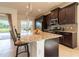 Kitchen with a large island, dark wood cabinets, and stainless steel appliances at 4888 Sevilla Shores Dr, Wimauma, FL 33598