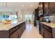 Open kitchen showcasing granite countertops, an island, and stainless steel appliances at 4888 Sevilla Shores Dr, Wimauma, FL 33598