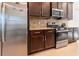 Modern kitchen featuring stainless steel appliances, granite countertops, and a tiled backsplash at 4888 Sevilla Shores Dr, Wimauma, FL 33598