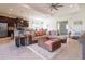 Bright and open living space featuring modern decor, tile flooring and an adjoining kitchen area at 4888 Sevilla Shores Dr, Wimauma, FL 33598