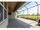 Screened patio with a view of the green backyard, offering shade and outdoor living space at 4888 Sevilla Shores Dr, Wimauma, FL 33598