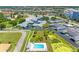 Enjoy community living with a pool in this aerial view of a charming community with mature landscaping at 4943 New England Blvd # 105, New Port Richey, FL 34652
