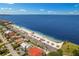 Scenic aerial view of beachfront community, sandy shore, and the open, blue ocean at 4943 New England Blvd # 105, New Port Richey, FL 34652