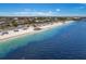 Gorgeous aerial perspective showcasing homes near a sandy beach and serene ocean waters at 4943 New England Blvd # 105, New Port Richey, FL 34652