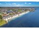Waterfront community aerial view with lush landscaping, sandy beach, and tranquil ocean waters at 4943 New England Blvd # 105, New Port Richey, FL 34652