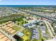 Aerial view showcases a waterfront neighborhood with a community pool, lush greenery, and scenic canal access at 4943 New England Blvd # 105, New Port Richey, FL 34652