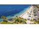 Scenic aerial view showcasing the beach and the inviting turquoise waters along the coastline at 4943 New England Blvd # 105, New Port Richey, FL 34652