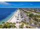 Stunning aerial view of the community beach featuring white sand, shady pavilions, and clear blue water at 4943 New England Blvd # 105, New Port Richey, FL 34652