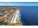 Overhead view of beach, parking and neighboring community with ocean access and serene blue waters at 4943 New England Blvd # 105, New Port Richey, FL 34652