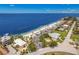 Stunning aerial view of beachfront homes with an expansive beach area and the ocean beyond at 4943 New England Blvd # 105, New Port Richey, FL 34652