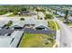 Aerial view of building exterior with attached garages, manicured lawns, and convenient parking spaces at 4943 New England Blvd # 105, New Port Richey, FL 34652