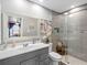 Bathroom featuring a modern vanity, mirror and glass enclosed shower at 4943 New England Blvd # 105, New Port Richey, FL 34652