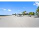 Beautiful beach setting with palm trees, sandy area, clear blue skies, and serene ocean views at 4943 New England Blvd # 105, New Port Richey, FL 34652