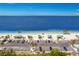 Beautiful beach with multiple cabanas and a row of palm trees, right across the street from parking at 4943 New England Blvd # 105, New Port Richey, FL 34652