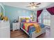 Comfortable bedroom with modern ceiling fan, and large window with bright light at 4943 New England Blvd # 105, New Port Richey, FL 34652