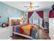Charming bedroom features a window seat, workout bike, and bright natural light at 4943 New England Blvd # 105, New Port Richey, FL 34652