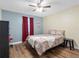 Second bedroom features a ceiling fan and hardwood floors at 4943 New England Blvd # 105, New Port Richey, FL 34652