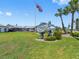 Holiday Harbors community sign with an American flag, well-kept lawn and palm trees at 4943 New England Blvd # 105, New Port Richey, FL 34652