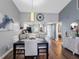 Bright dining area featuring modern decor, wood floors, and an open layout to the kitchen at 4943 New England Blvd # 105, New Port Richey, FL 34652