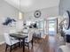 Bright dining area featuring modern decor, wood floors, and an open layout to the kitchen at 4943 New England Blvd # 105, New Port Richey, FL 34652