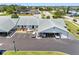Exterior view of the unit and parking spaces, boasting modern design with carports and a well-maintained lawn at 4943 New England Blvd # 105, New Port Richey, FL 34652