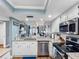 Open kitchen with granite countertops, appliances, and seamless flow into living space at 4943 New England Blvd # 105, New Port Richey, FL 34652