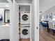 Convenient laundry closet featuring stackable washer and dryer in bright hallway at 4943 New England Blvd # 105, New Port Richey, FL 34652