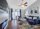 Inviting living room features a cozy fireplace, ceiling fan, and lots of natural light at 4943 New England Blvd # 105, New Port Richey, FL 34652