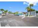 Street view showcasing a blue building with palm trees and parking area in a coastal neighborhood at 4943 New England Blvd # 105, New Port Richey, FL 34652