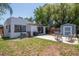 Backyard area with a storage shed, patio, hot tub, and partial fence at 513 W Paris St, Tampa, FL 33604