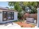 Backyard featuring a private hot tub, manicured lawn, mature trees, and lush landscaping at 513 W Paris St, Tampa, FL 33604