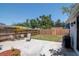 Landscaped backyard with patio seating, grill, and surfboard rack, ideal for outdoor living and entertaining at 513 W Paris St, Tampa, FL 33604