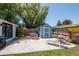 This backyard features a storage shed, hot tub, patio, and fenced in yard at 513 W Paris St, Tampa, FL 33604