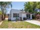 The backyard features a grill, patio, and white stucco exterior, perfect for outdoor entertaining at 513 W Paris St, Tampa, FL 33604