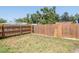A grassy backyard with a wood fence provides privacy for the property at 513 W Paris St, Tampa, FL 33604