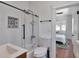 A modern bathroom with a glass-enclosed shower, unique tile work, and an attached bedroom at 513 W Paris St, Tampa, FL 33604